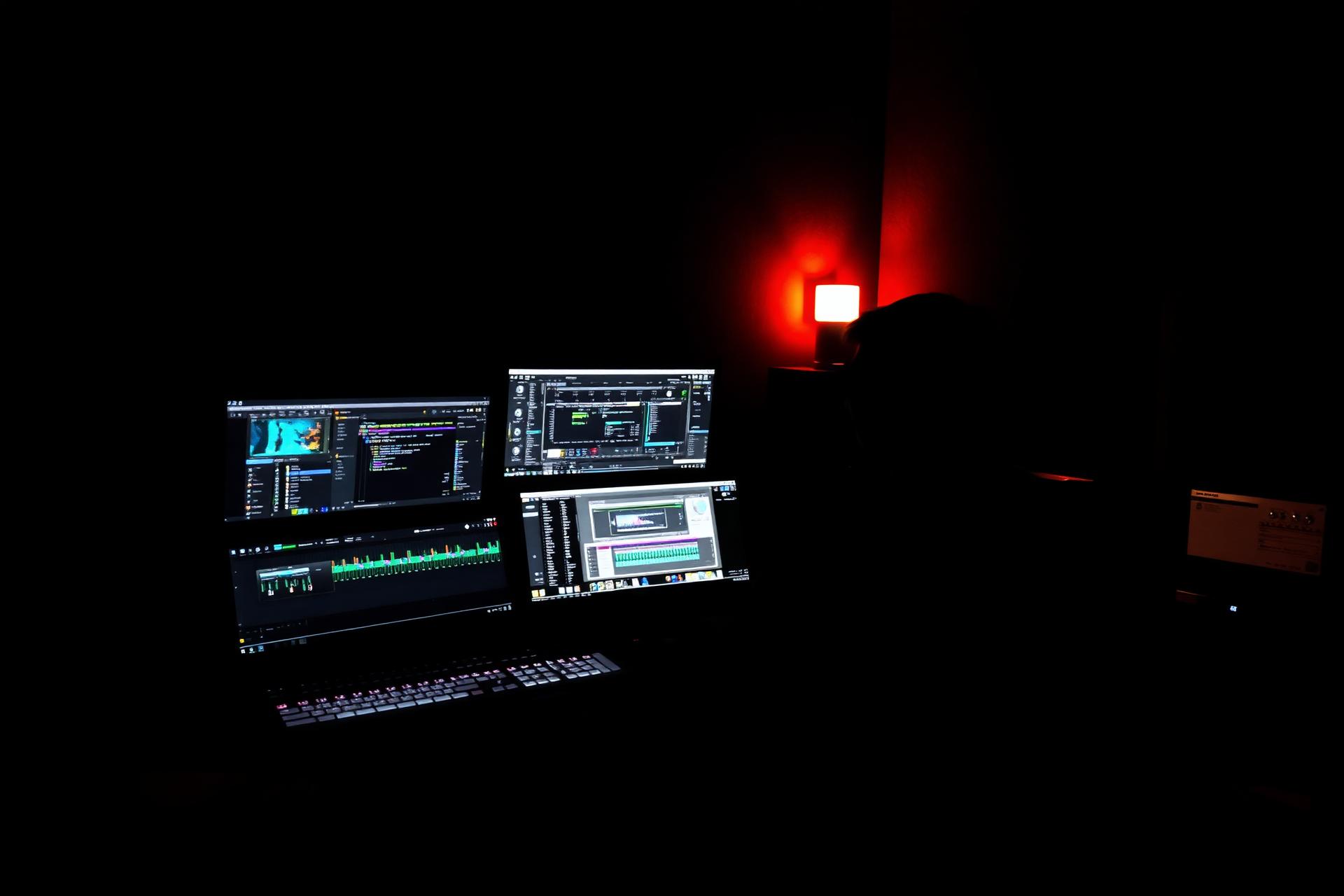 Music producer working on a multi-monitor workstation